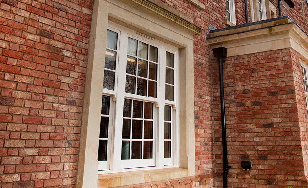 Large white uPVC sliding sash double glazed window