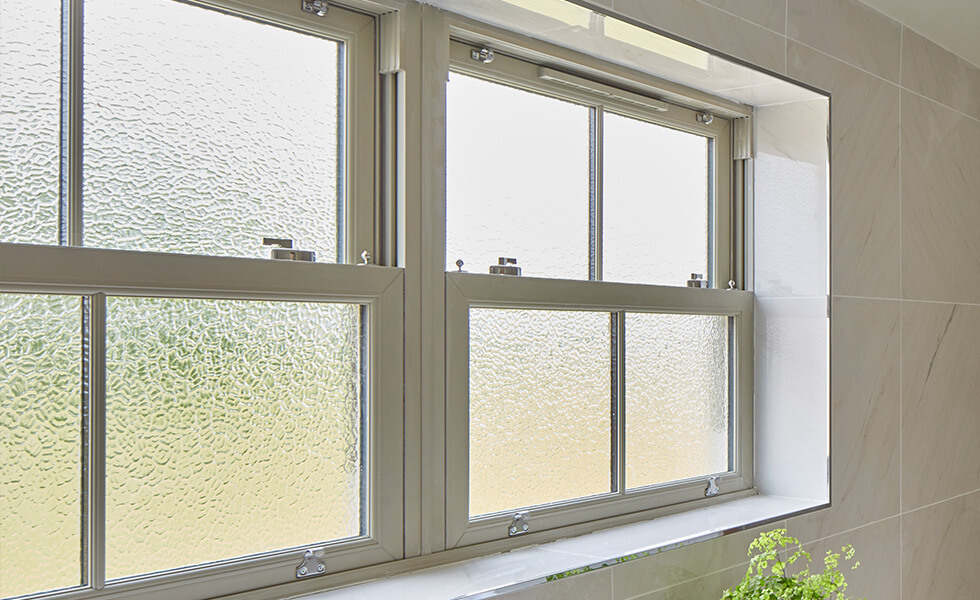 uPVC sliding sash window interior view with textured glass