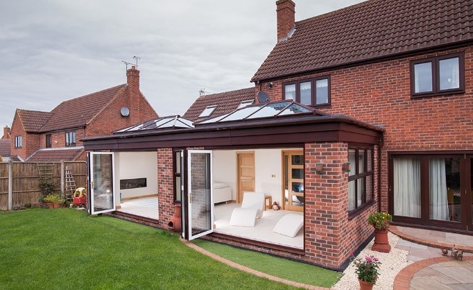 brick and brown frame double conservatory