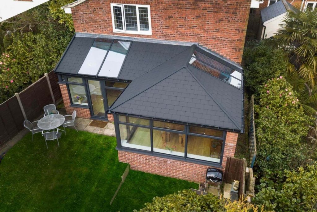 p-shape conservatory with a brown tiloed roof from above