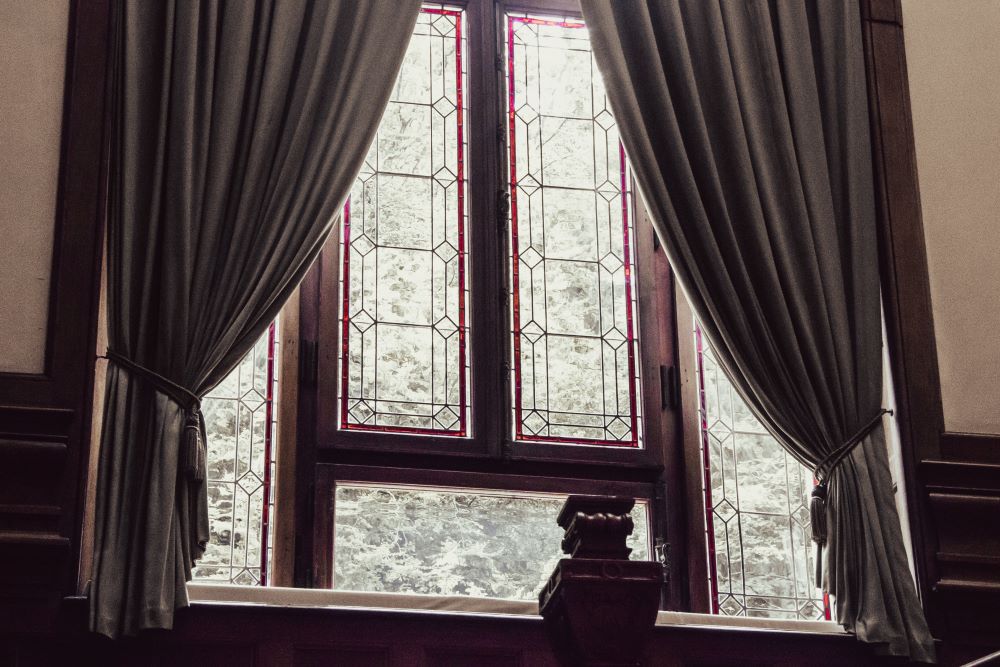 Old curtains in front of an old window.