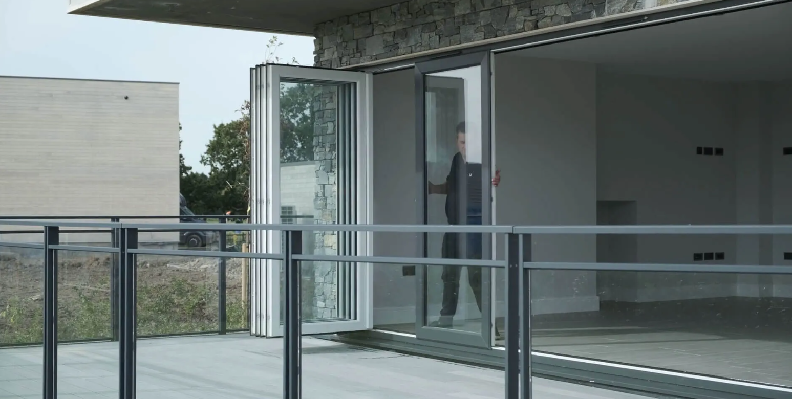 Quickslide's aluminium slide and fold doors, open on a balcony